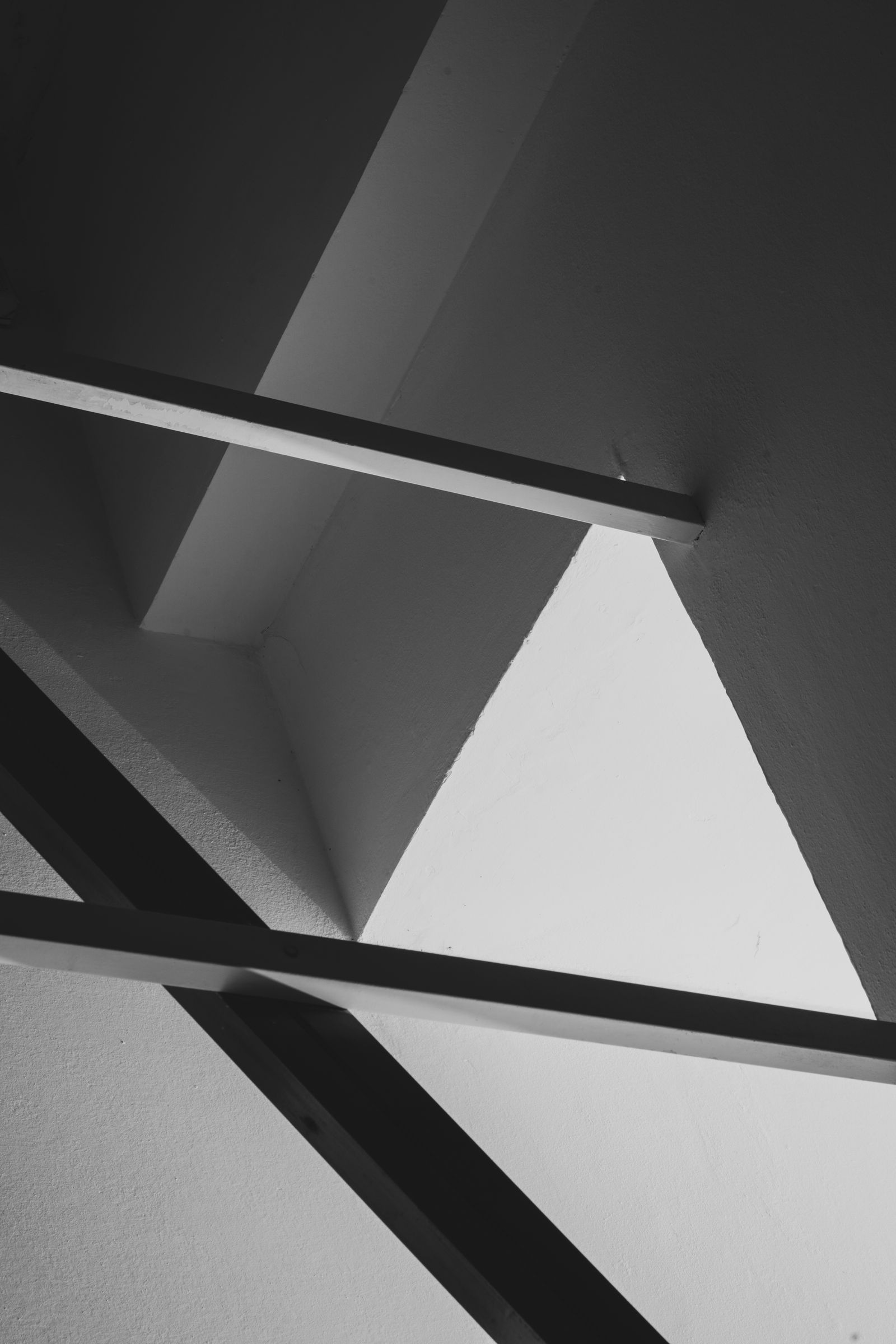 High-contrast architectural shadows representing a narrow and protected infrastructure authority path.