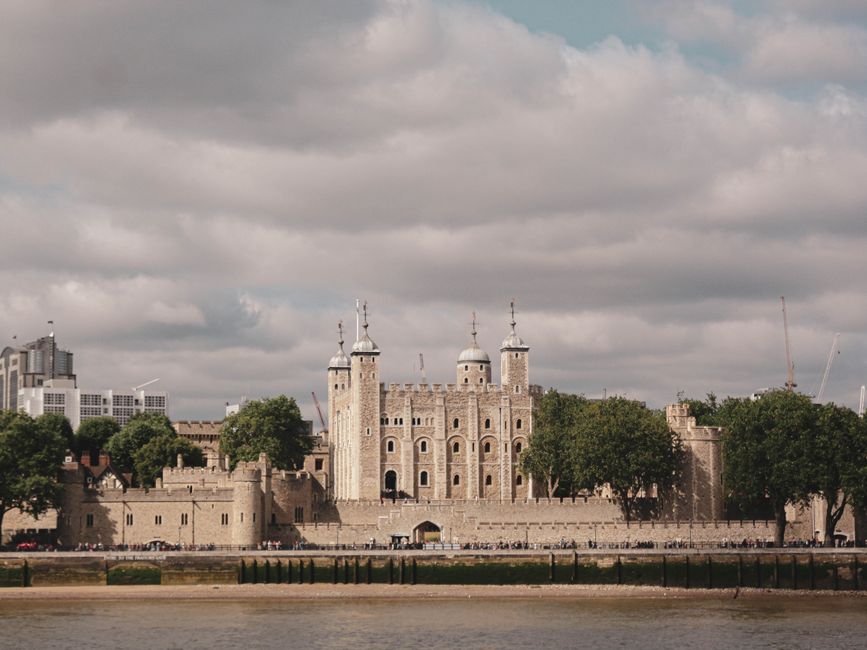 The Tower of London captured in daylight, highlighting its historic architecture along the Thames River.