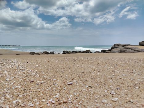 Experience the tranquil beauty of Pothuvil Beach in Sri Lanka with its pristine sands and clear skies.