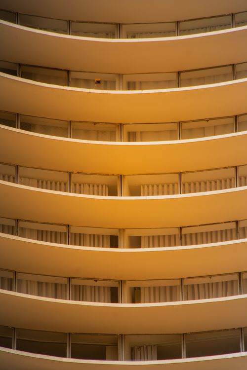 Free Close-up view of curved balconies with golden light, highlighting modern architectural design. Stock Photo