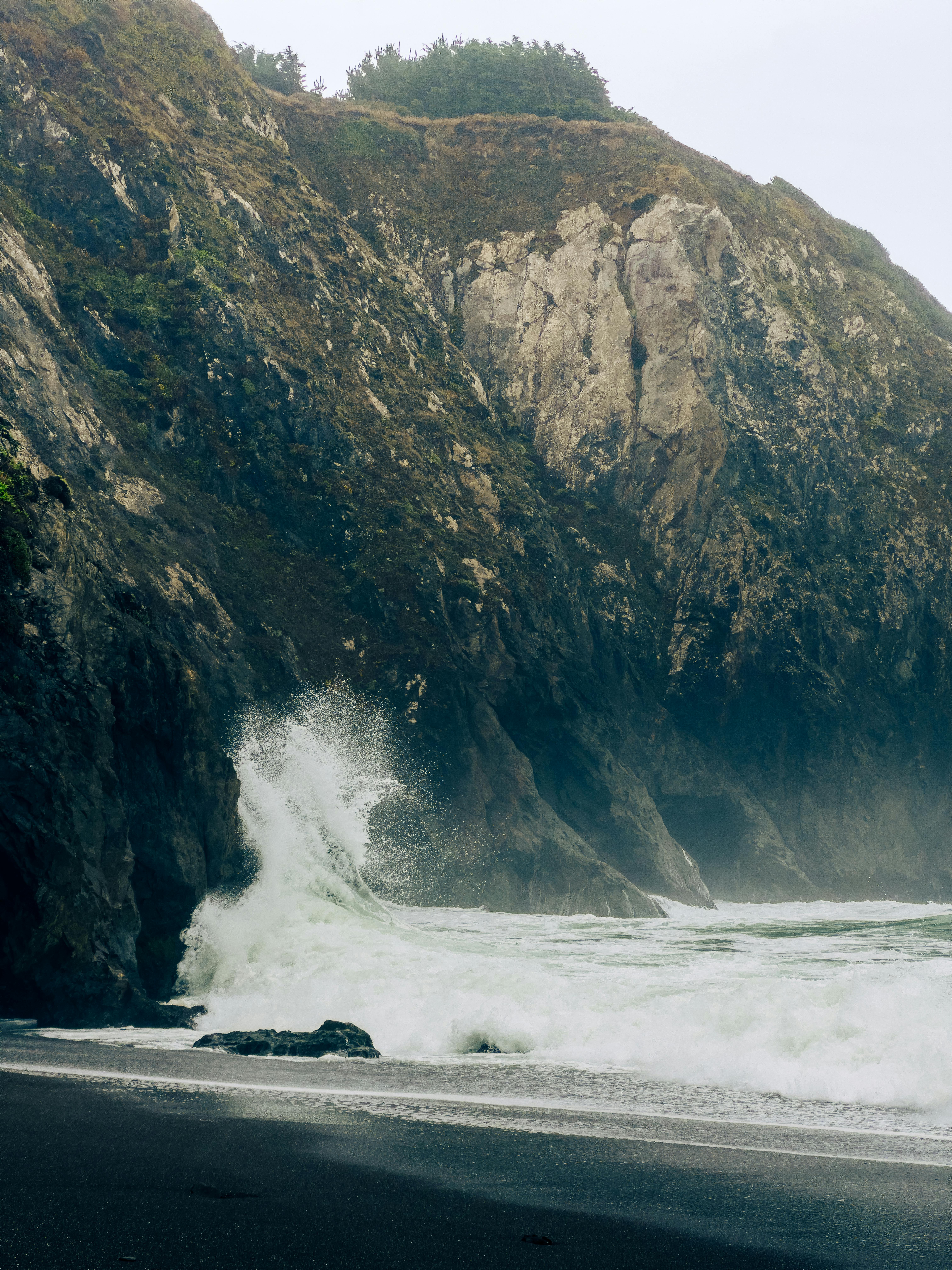 Dramatic waves crashing against rugged California cliffs on the Lost Coast, Humboldt County