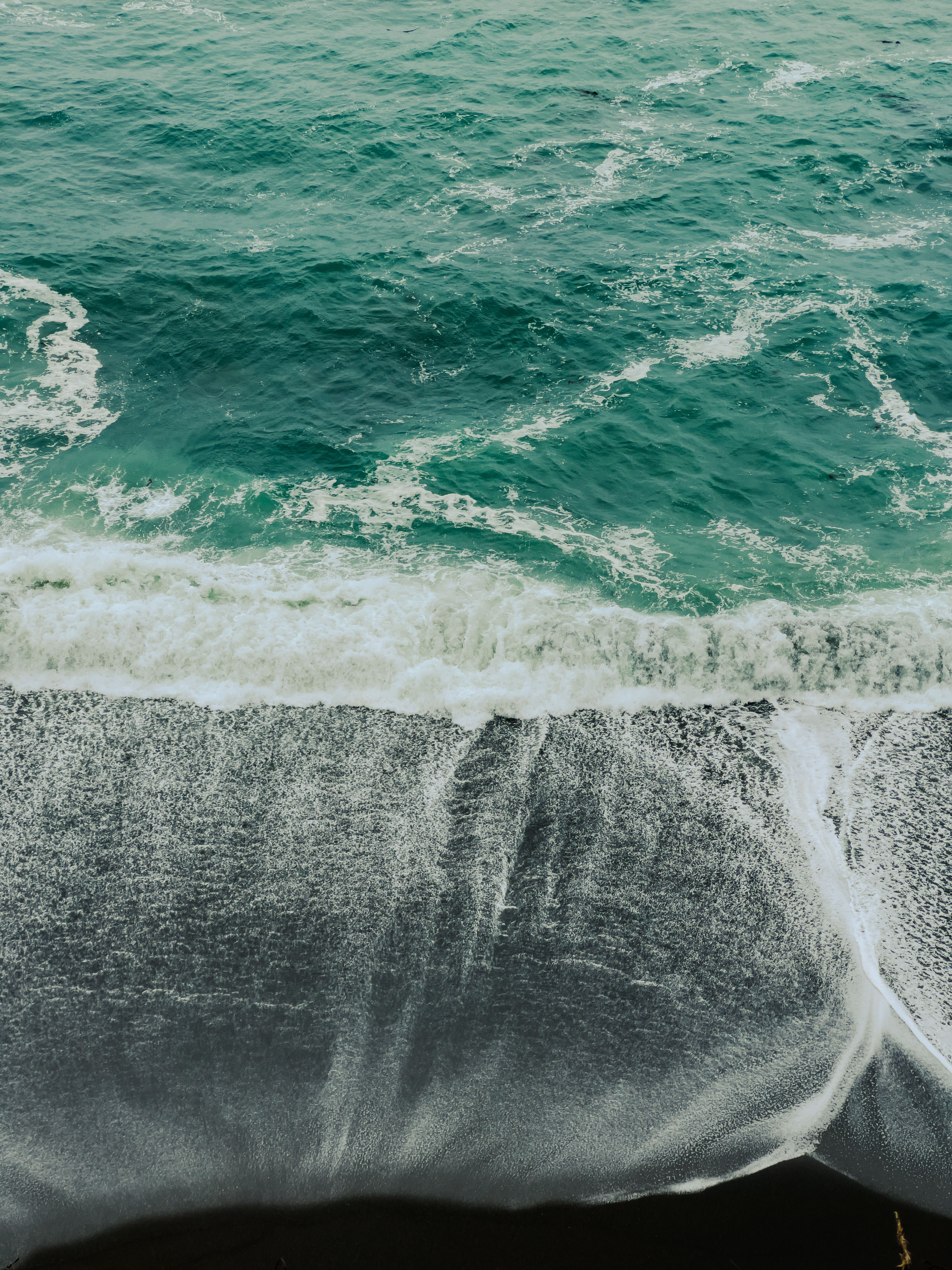 A powerful wave crashes onto a rocky shore, capturing the dynamic beauty of the ocean's movement.