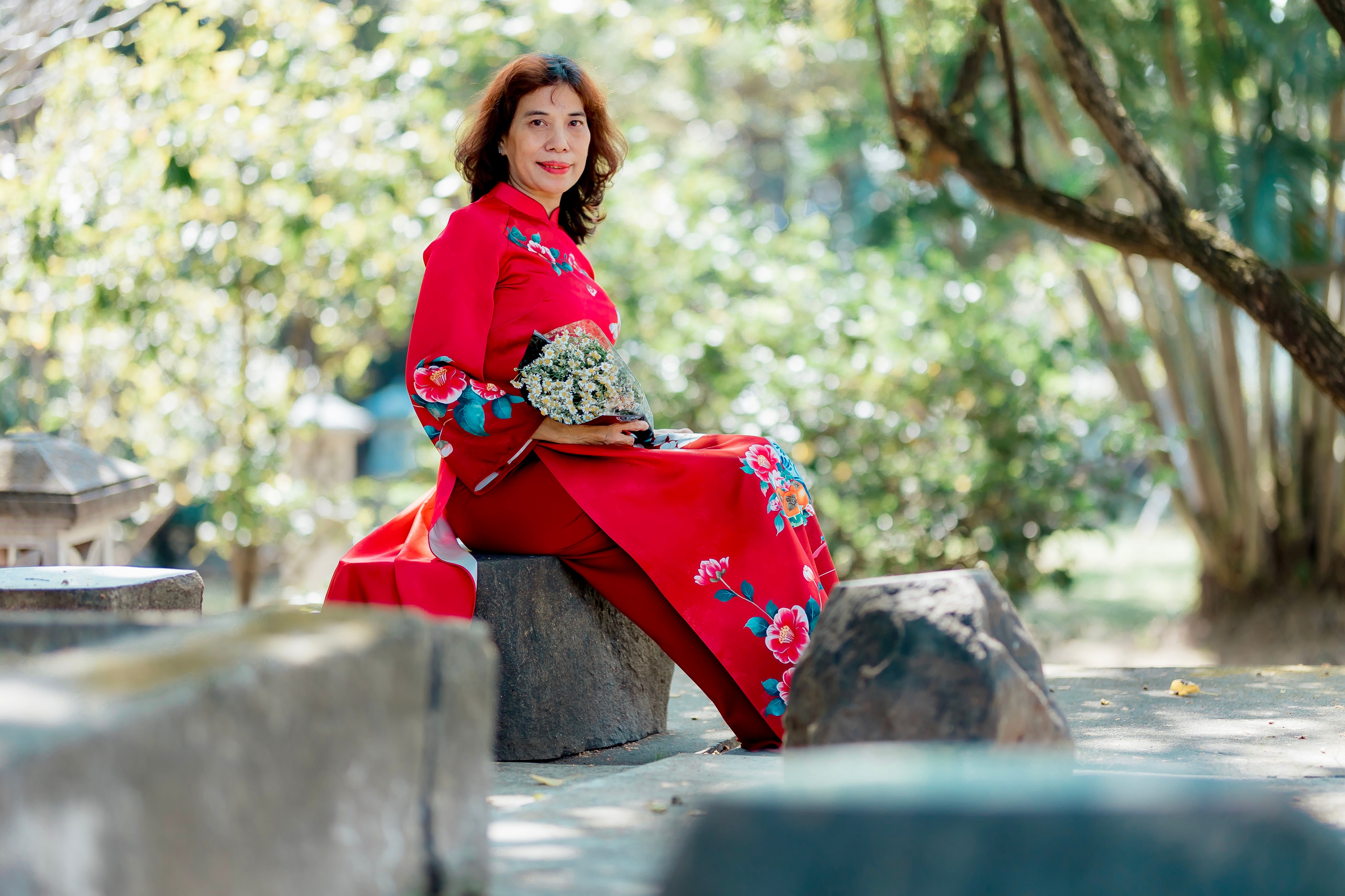 Elegant Woman in Red Floral Dress in Tranquil Park · Free Stock Photo