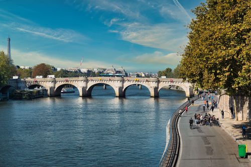 Free Beautiful daytime view of Pont Neuf and the Seine River in Paris with cyclists and pedestrians. Stock Photo