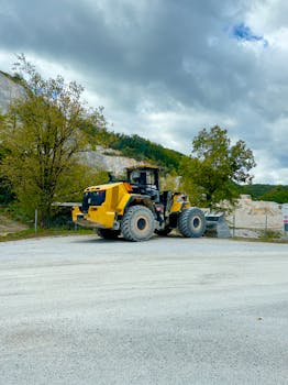 A powerful yellow bulldozer in a Croatian quarry, showcasing construction equipment amidst nature.