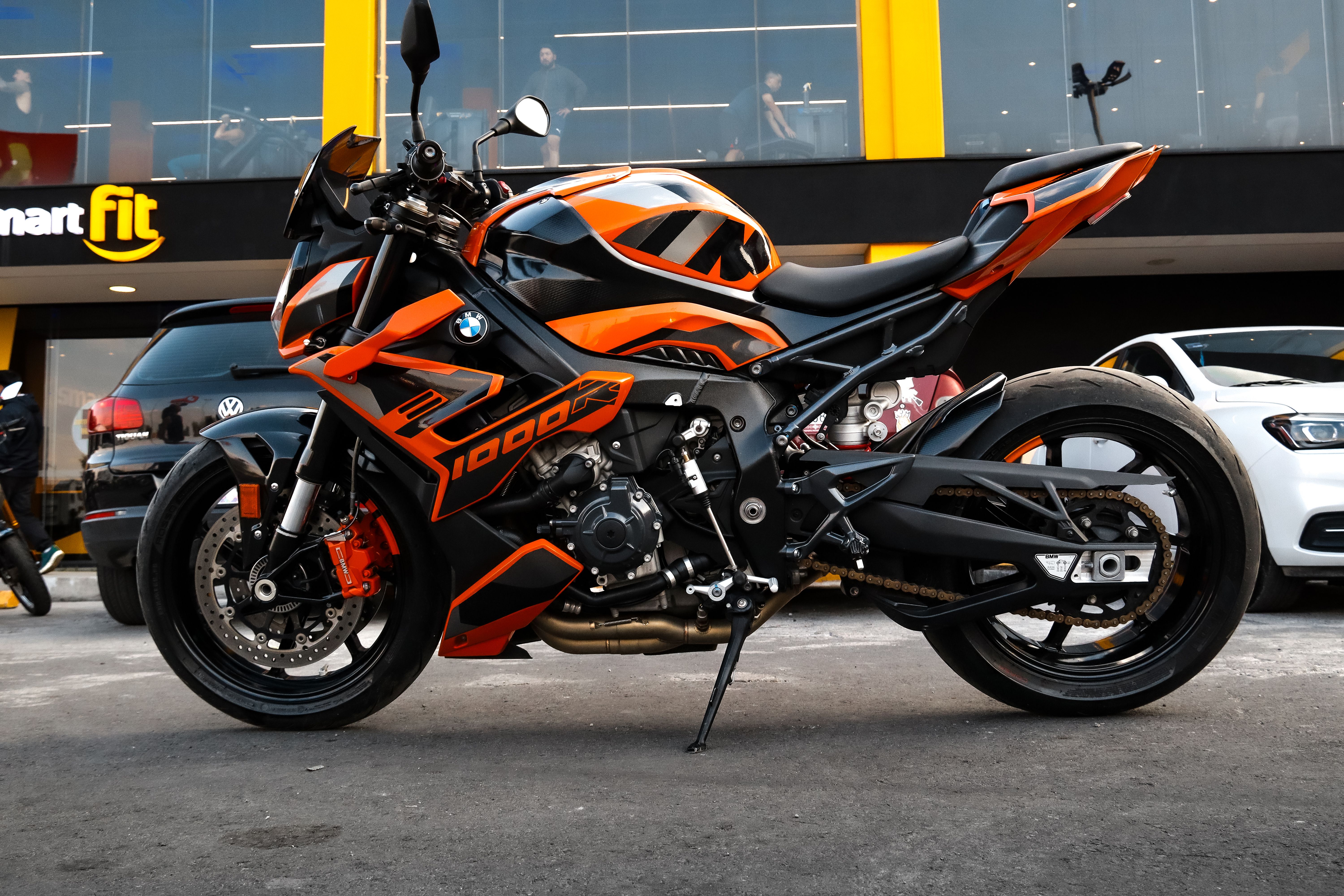 Vibrant Orange Sport Motorcycle in Urban Setting · Free Stock Photo