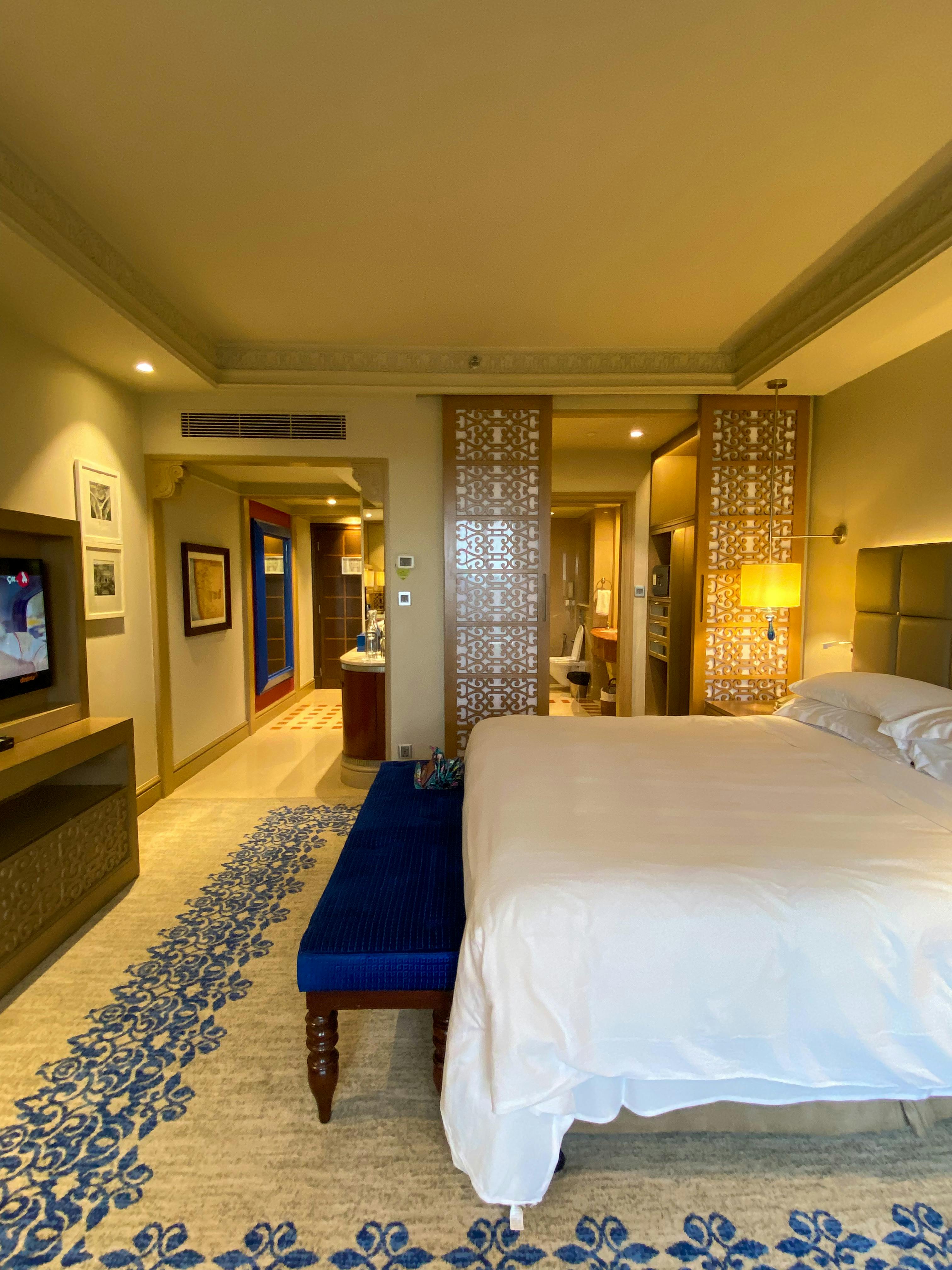 Spacious luxury hotel room with elegant decor and modern amenities located in Mumbai, India.