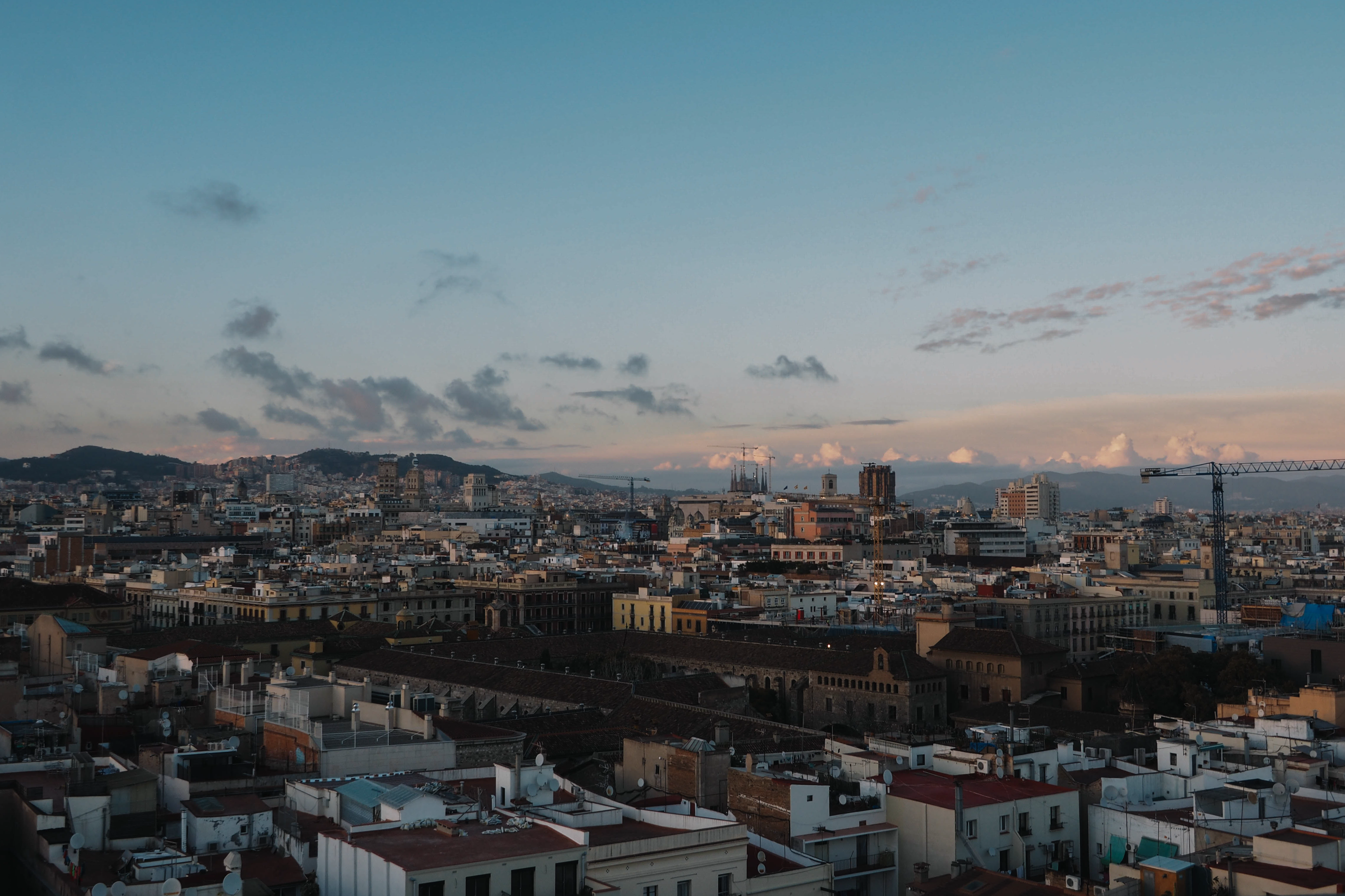 Stunning aerial view of Barcelona skyline during sunset, showcasing historic architecture.
