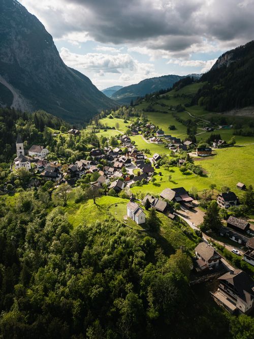 Free Explore the lush green landscapes of Styria with this stunning aerial view of an Alpine village. Stock Photo