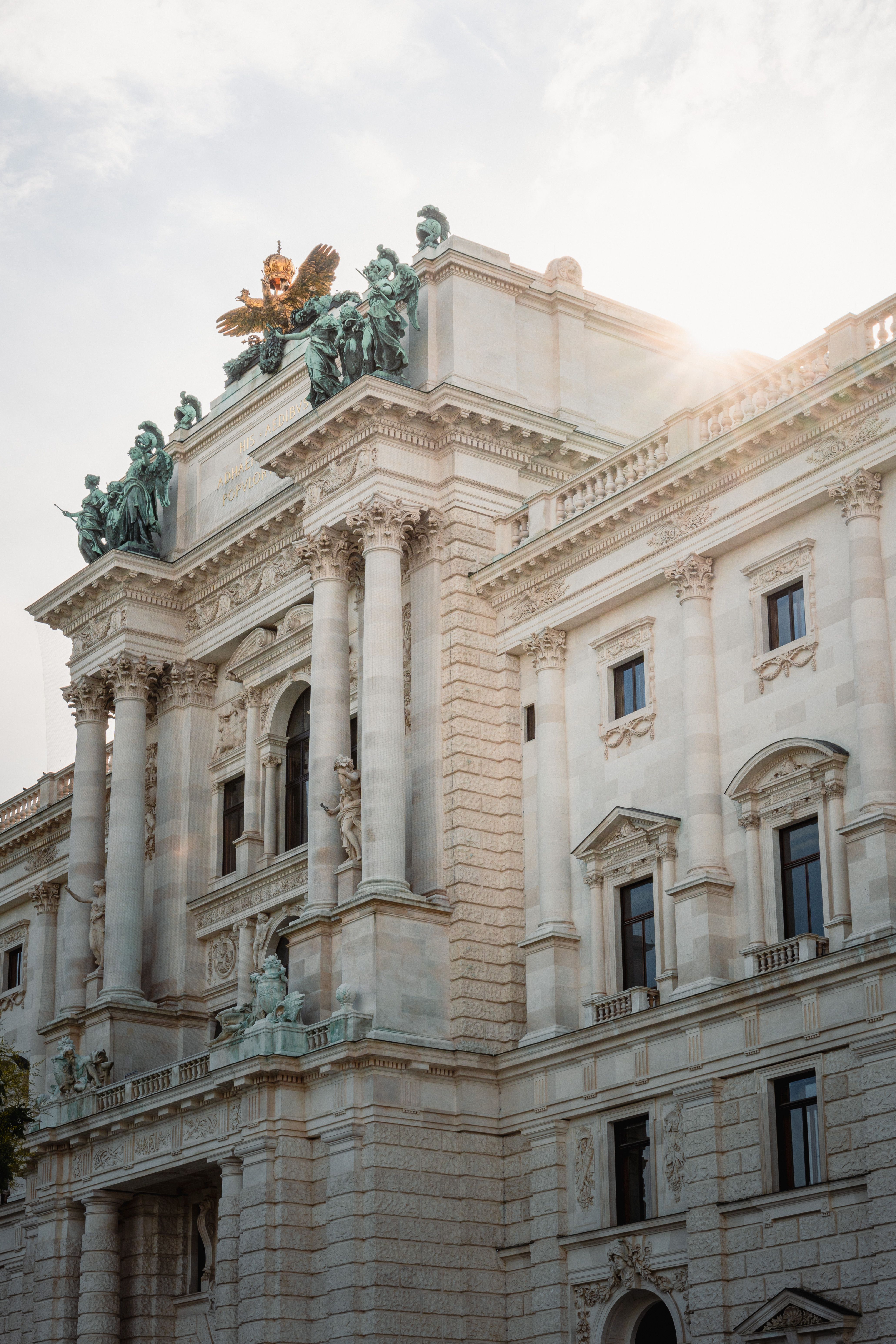 Elegant architecture of a historic building in Vienna, captured at sunset with beautiful sunlight effects.