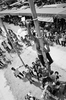 Energetic scene of a climbing game in Chonburi, Thailand, showcasing teamwork and excitement.