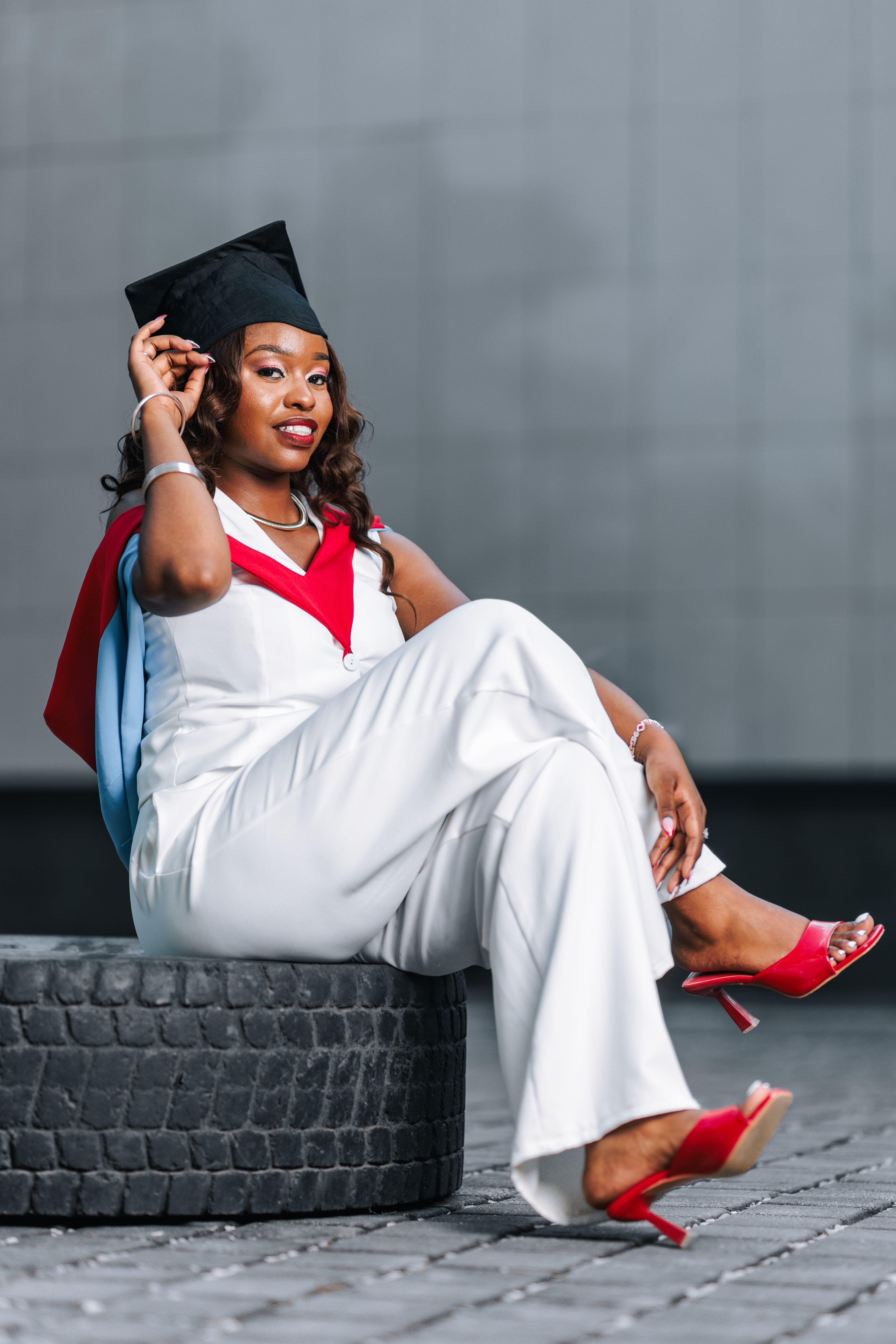 Confident Graduate Posing in Cap and Gown · Free Stock Photo