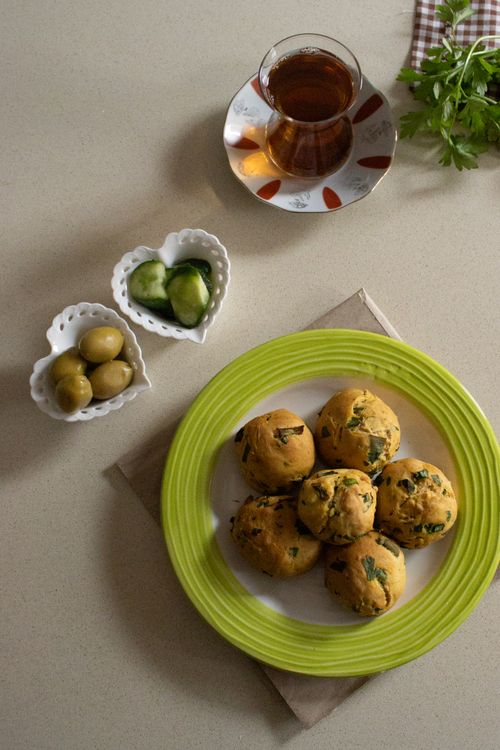 Free Plate of savory pastries with tea, olives, and cucumber slices. Stock Photo