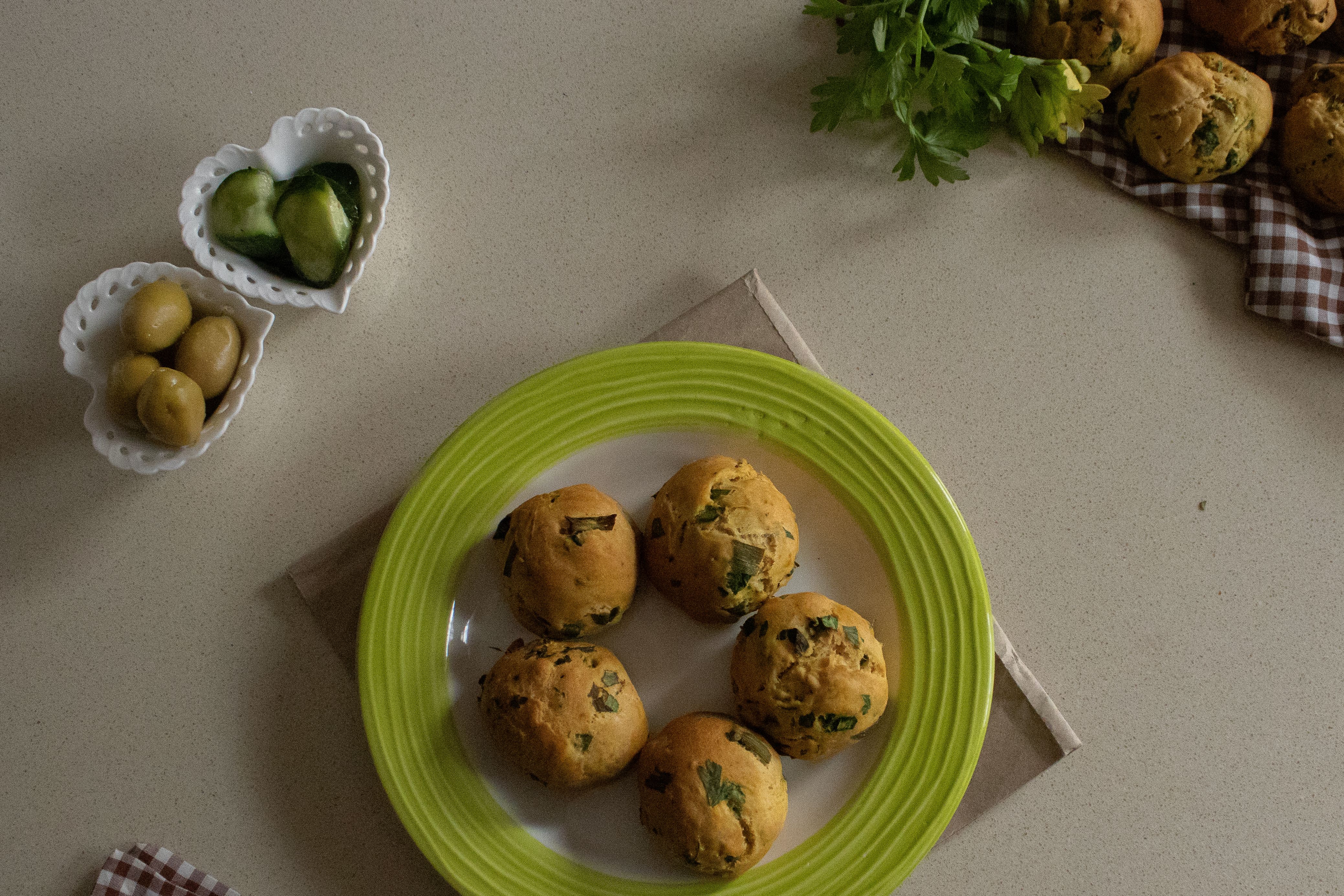 Golden olive biscuits on baking sheet fresh from oven