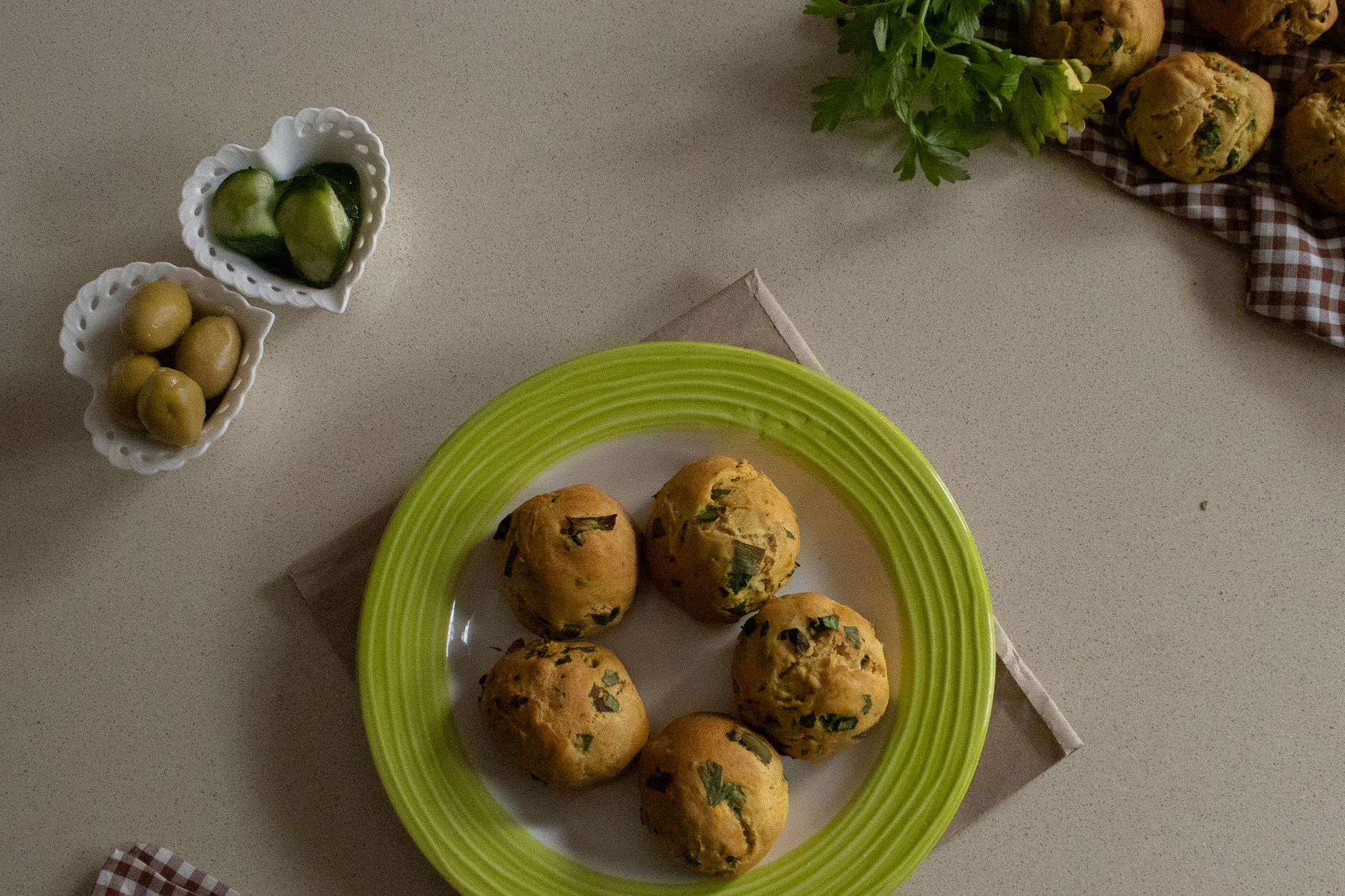 Golden olive biscuits on baking sheet fresh from oven