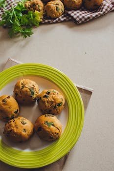 Tasty homemade herb rolls on a green plate, perfect for a cozy brunch or dinner.