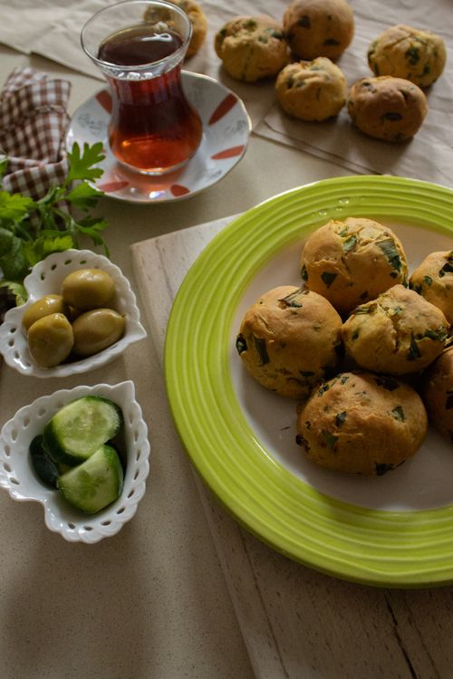 Free Delicious Turkish breakfast spread with savory scones, olives, and tea. Stock Photo
