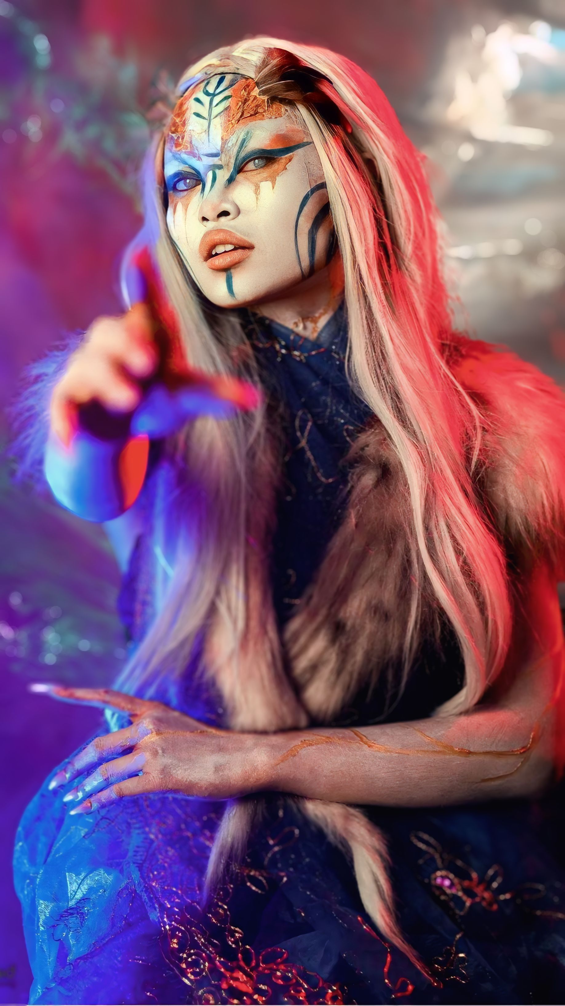 Colorful fantasy character portrait with vibrant makeup and intricate costume design.