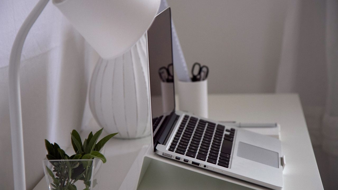 Ergonomic minimalist computer workstation Modern home office desk with laptop lamp and organized workspace for comfortable computer work