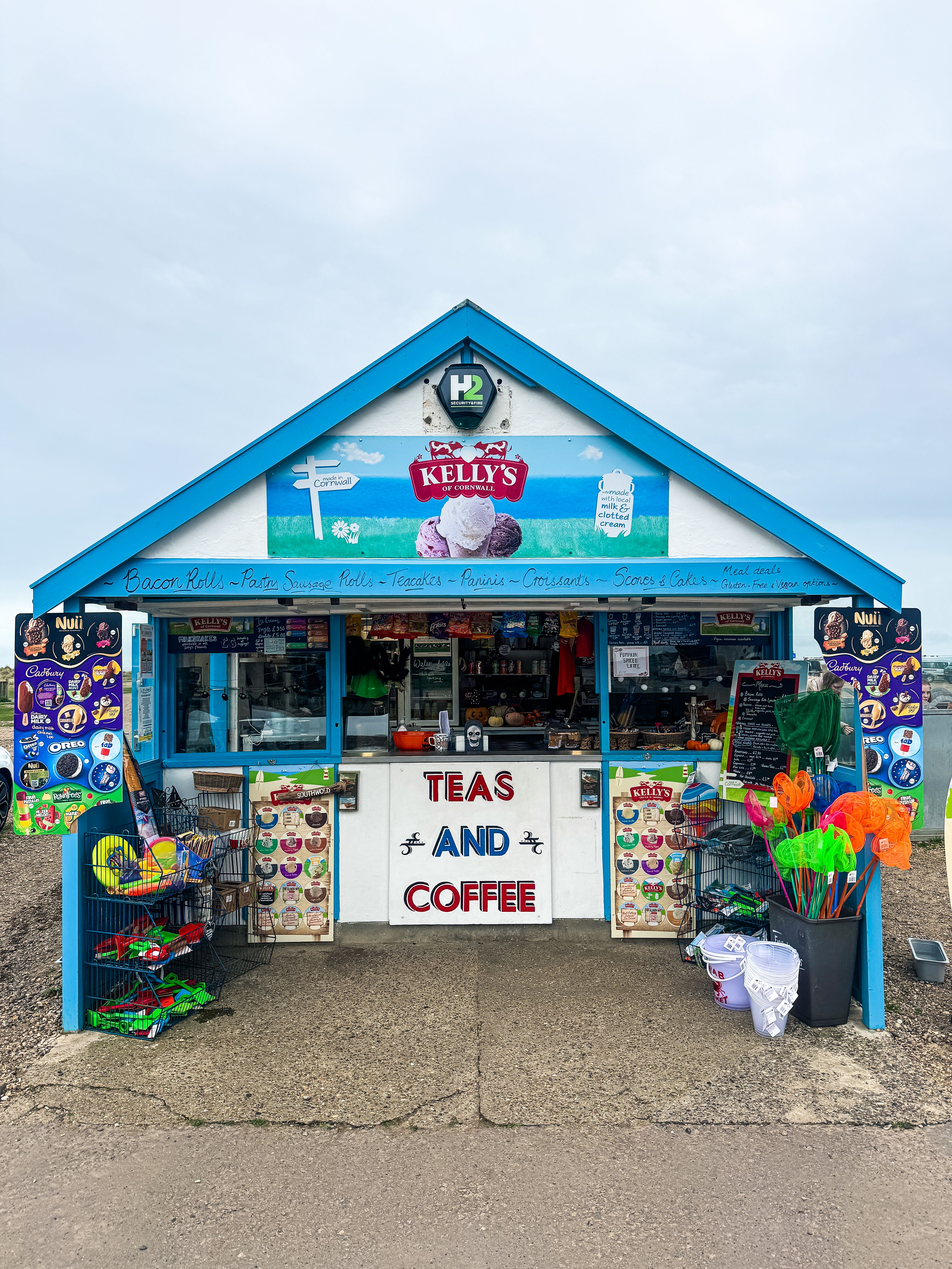 Vibrant seaside shack selling teas, coffee, and beach toys in Southwold, England.