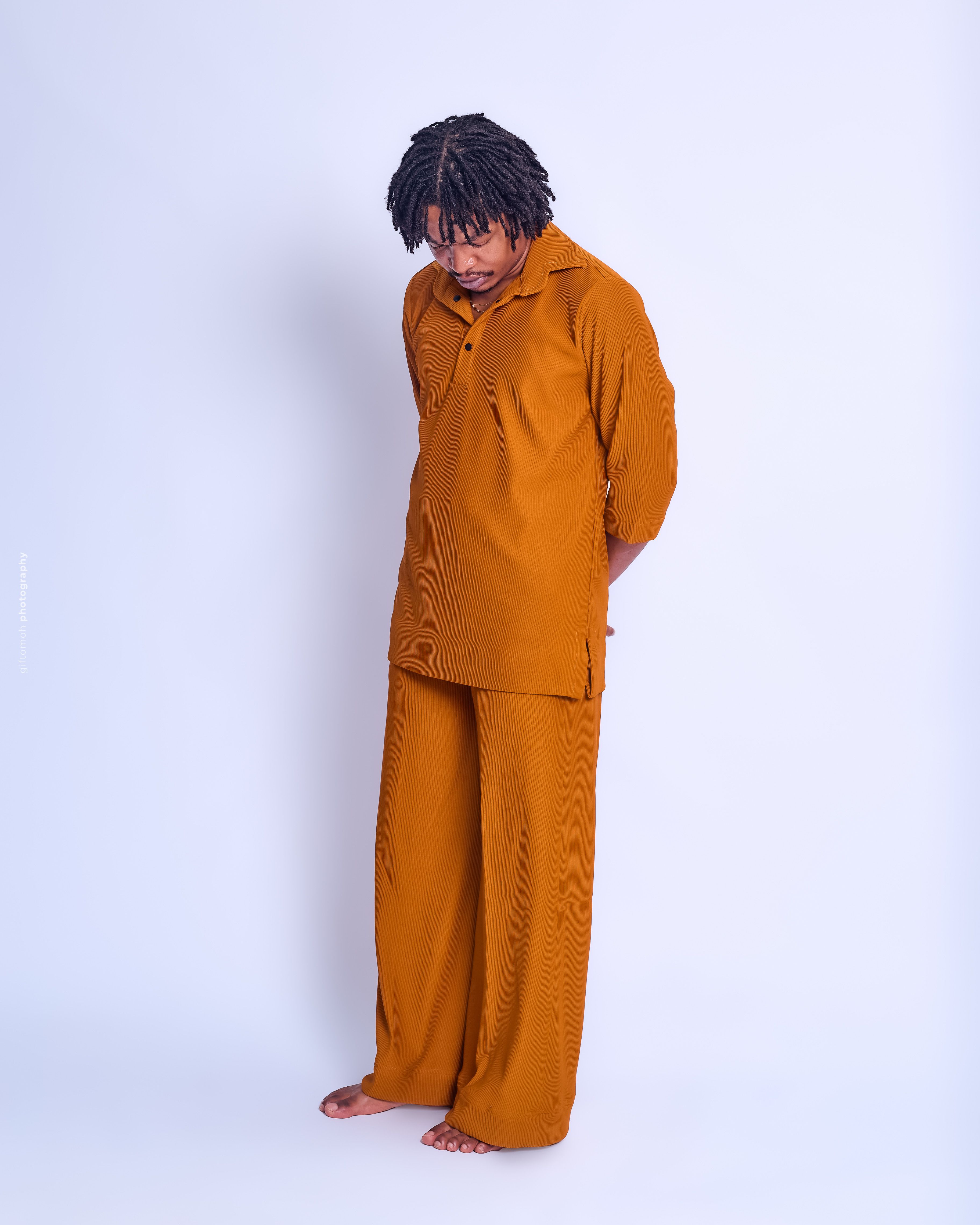 Contemplative Man in Rust-Colored Outfit Portrait · Free Stock Photo