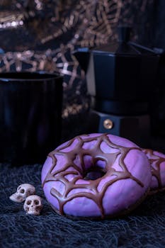Purple donuts with a chocolate spider web design perfect for Halloween parties.
