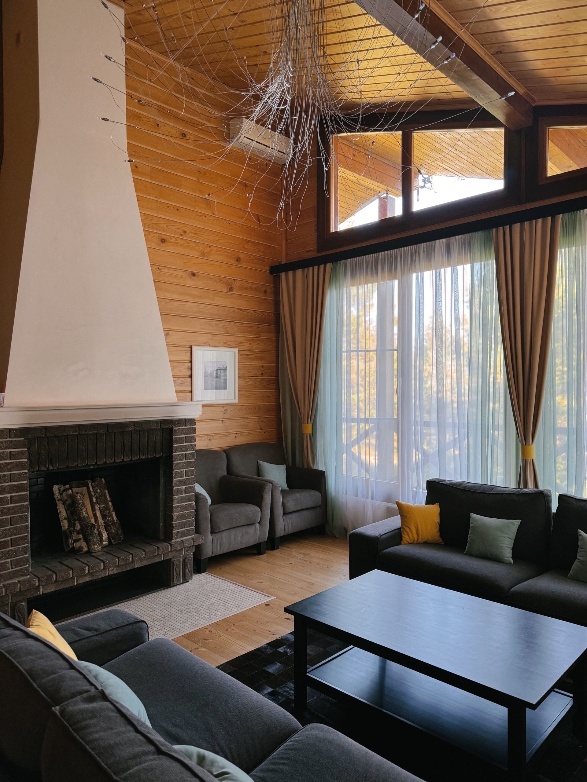 Cozy Living Room with Large Windows and Fireplace · Free Stock Photo