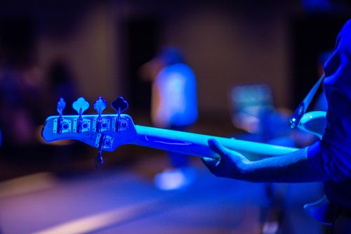 Free Close-up of a bass guitar in blue stage light during a concert. Stock Photo