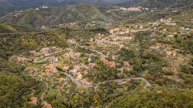 Explore the stunning aerial view of Gameragna village nestled in Liguria's lush hills.