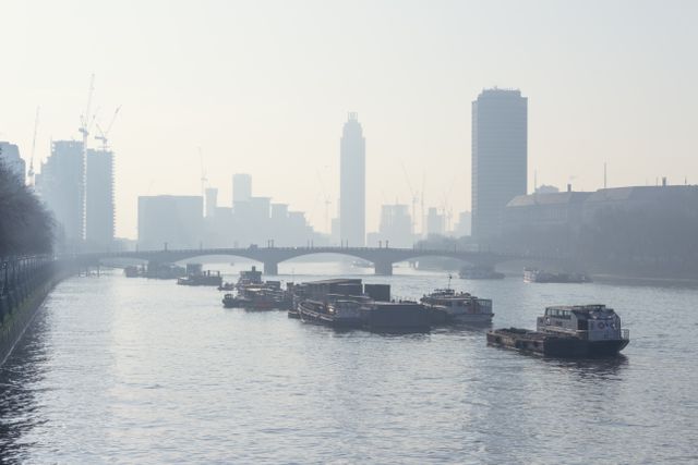 Barges on a misty river in the city — photo by Dom J on Pexels