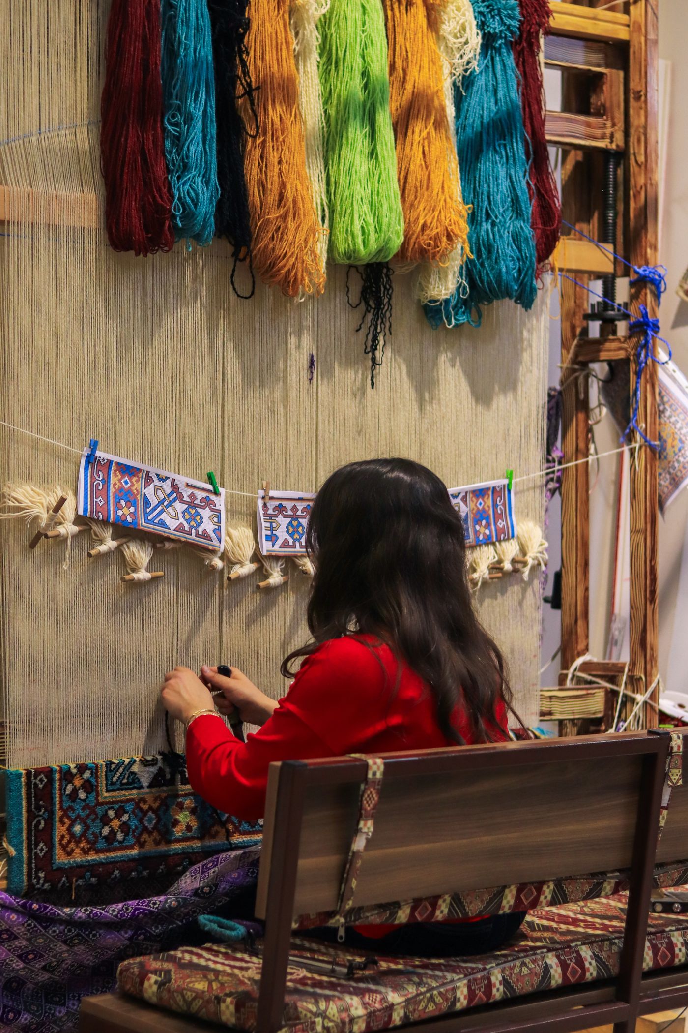 Artisan creating hand knotted rug