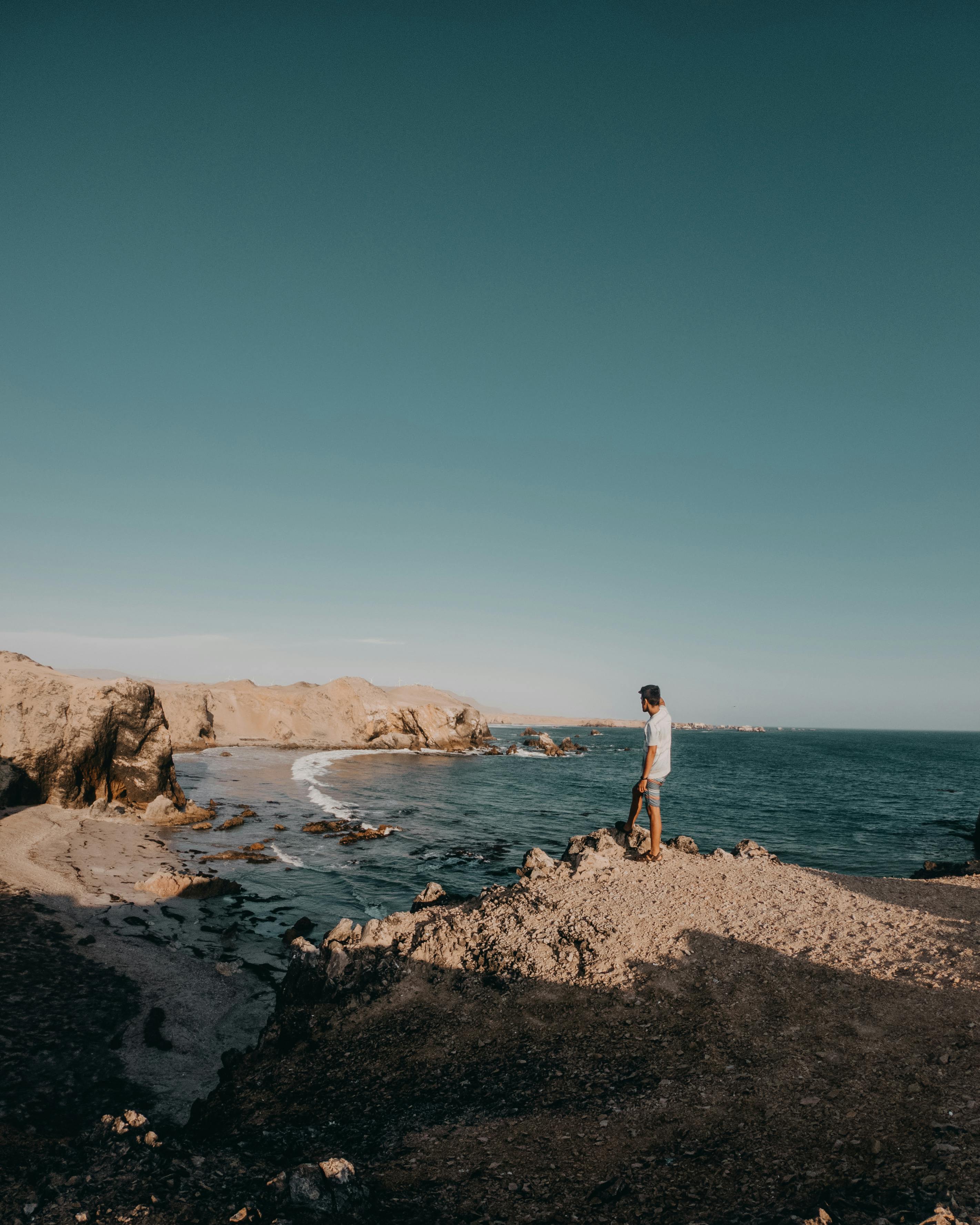 Man enjoying the tranquil coastal landscape in San Juan de Marcona, Peru.