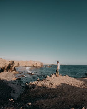 Man enjoying the tranquil coastal landscape in San Juan de Marcona, Peru.