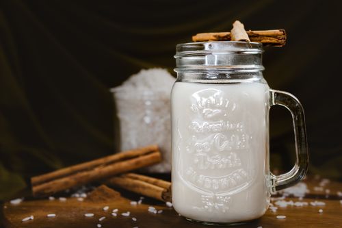 Free Refreshing traditional Mexican horchata served in a mason jar with cinnamon sticks. Stock Photo