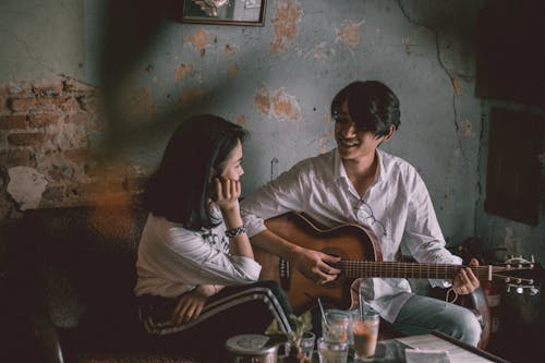 Free Man Playing Guitar With Girl Stock Photo