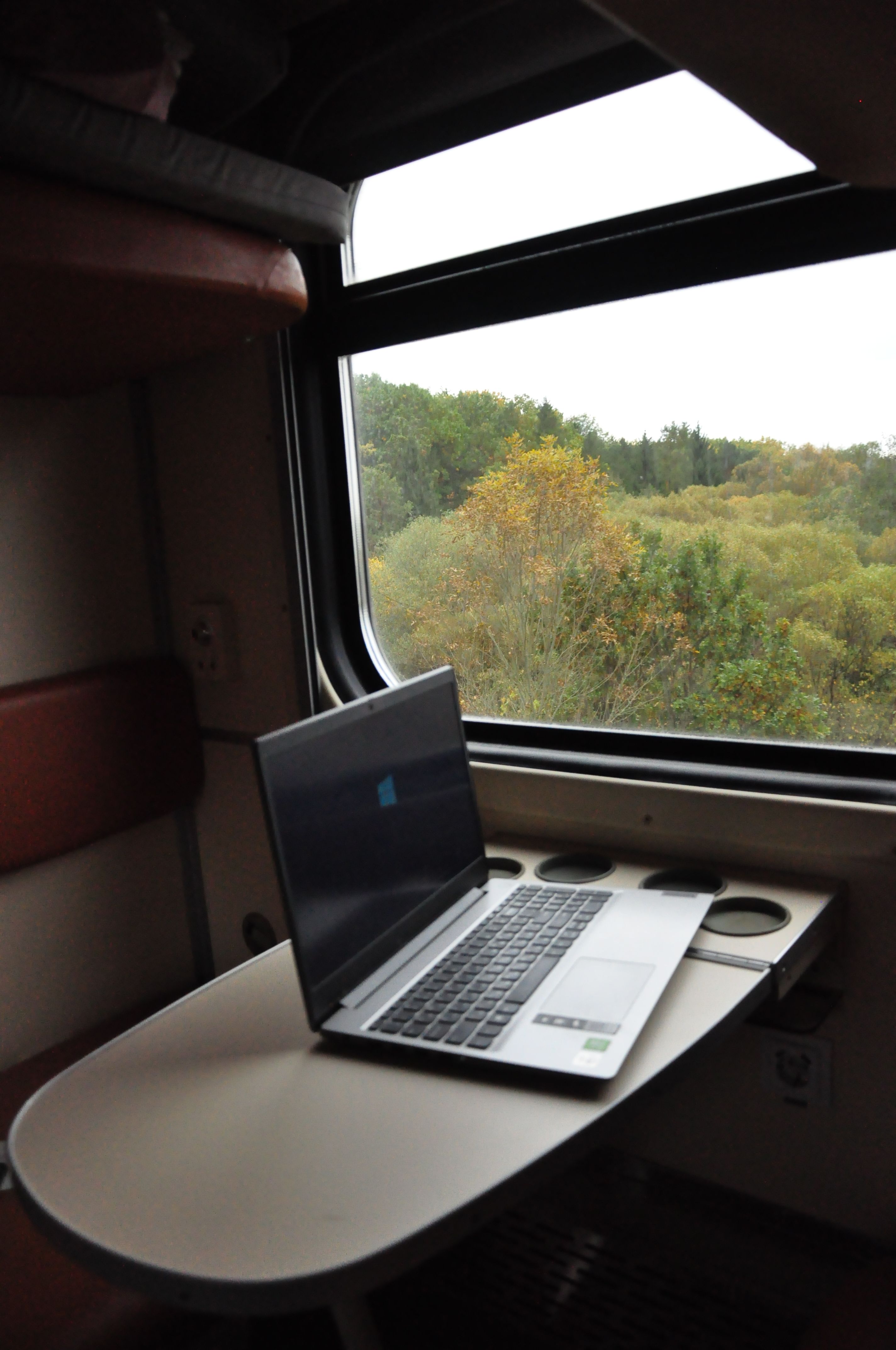 Laptop Setup in Train Cabin with Scenic View · Free Stock Photo