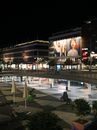 Vibrant night view of Sergels Torg in Stockholm with bustling city lights and modern architecture.