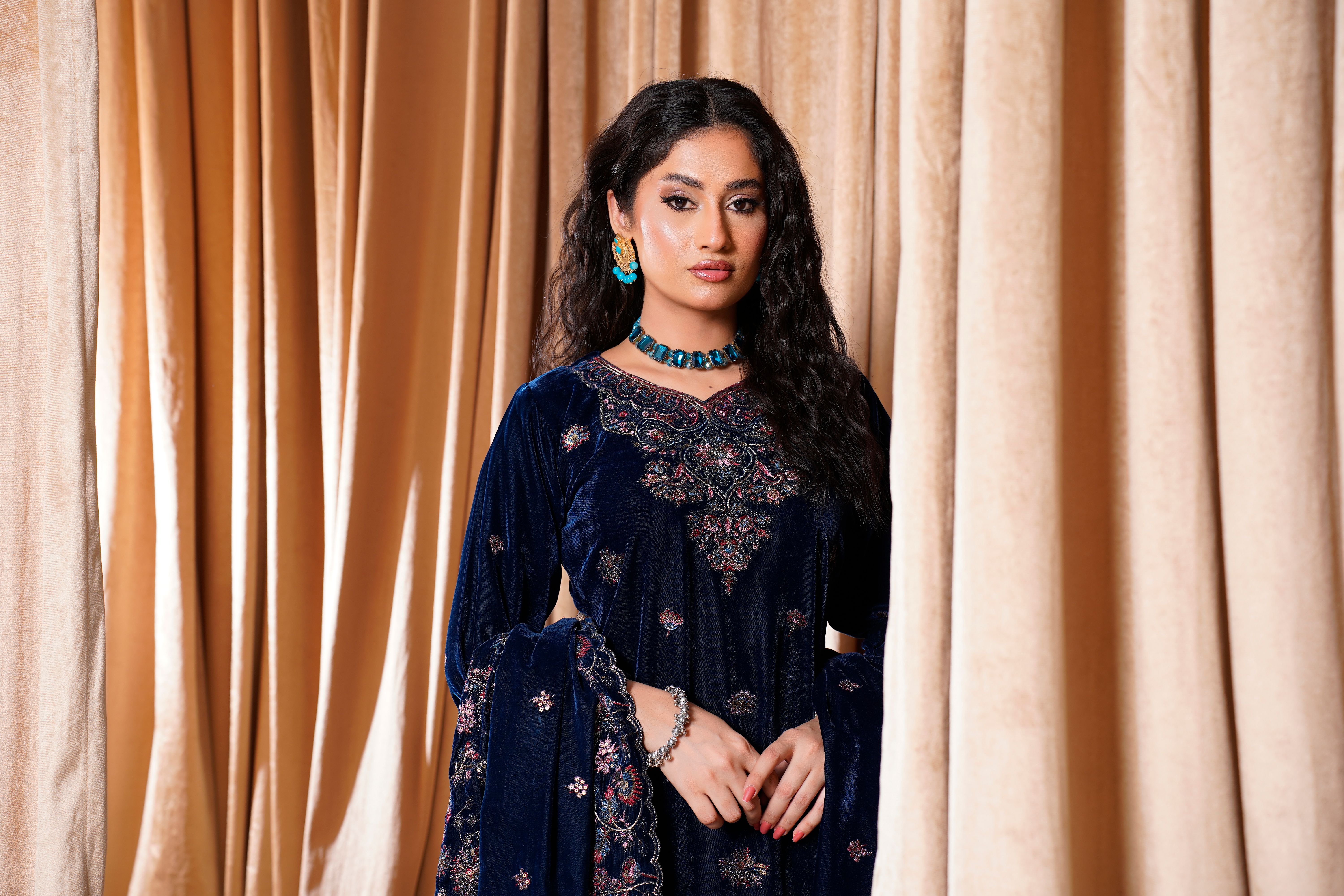 Fashion model in a luxurious embroidered velvet dress, Lahore, Pakistan.