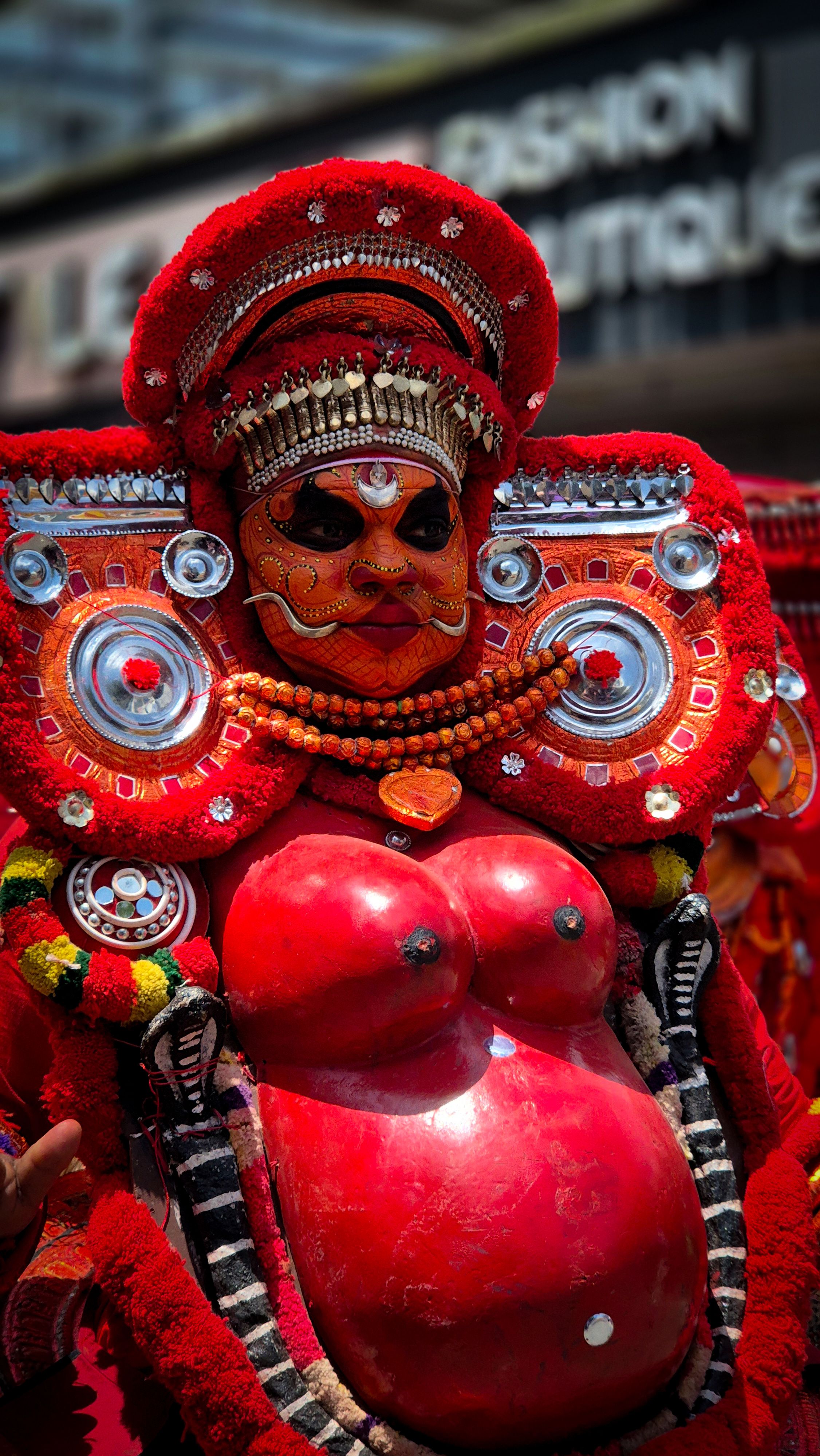A vibrant Theyyam performer in Kochi, showcasing Kerala's cultural heritage.