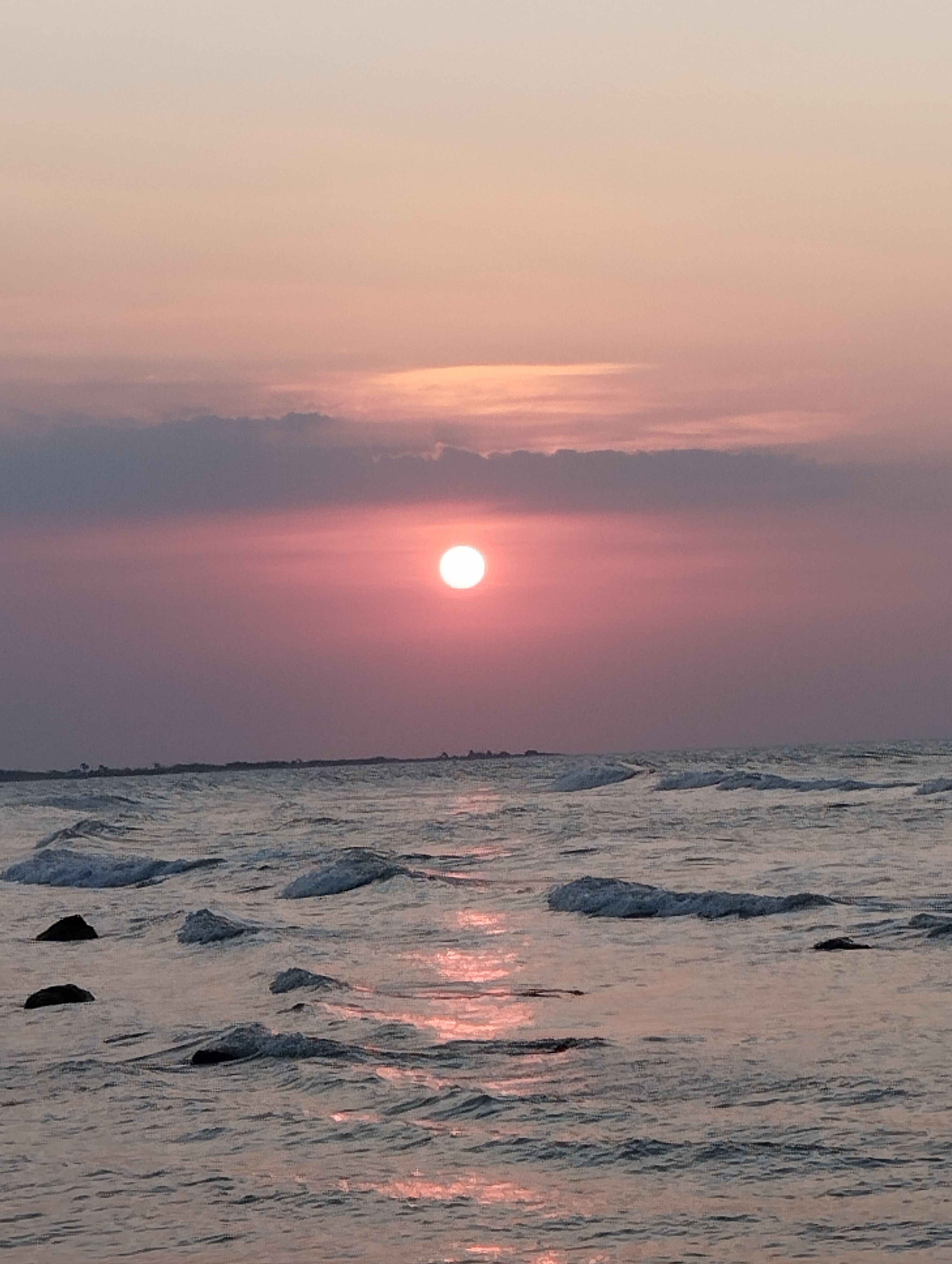 Serene Beach Sunset Over Calm Ocean Waves · Free Stock Photo