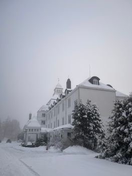 A historic building covered in snow during winter, creating a serene and elegant atmosphere.