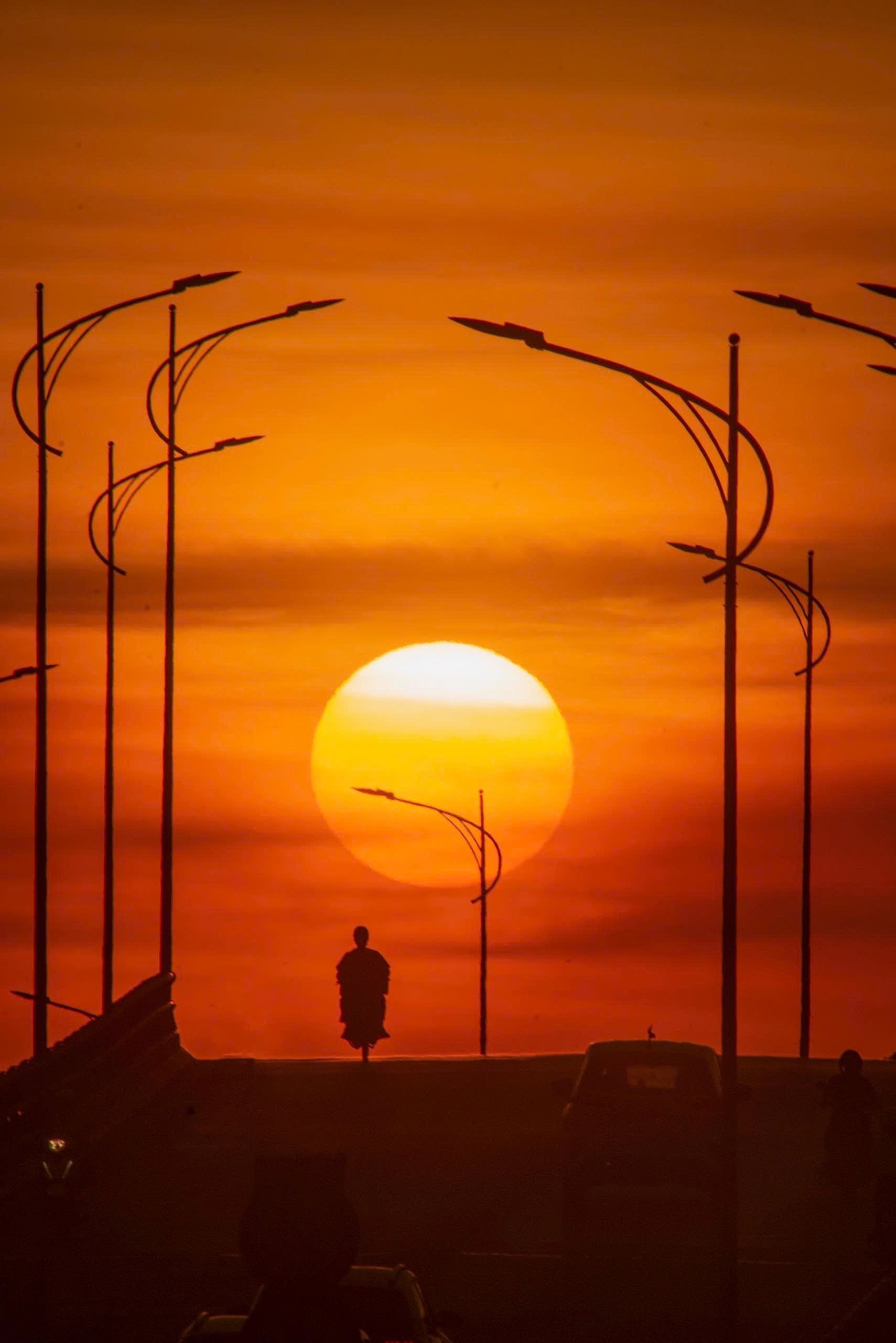 Silhouette of Person and Streetlights at Sunset · Free Stock Photo