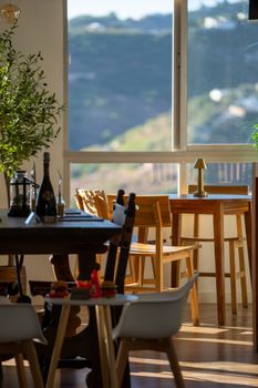 Warm indoor cafe with wooden furniture and mountain view in Frigiliana, Spain.