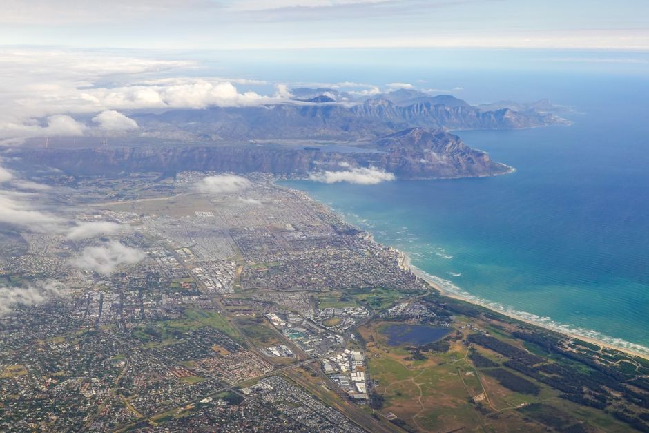 Stunning Helicopter and Hike Tour, Long March to Freedom, Table Mountain Review Review 2026 - A stunning aerial view of Cape Town with Table Mountain and coastline under a cloudy sky.