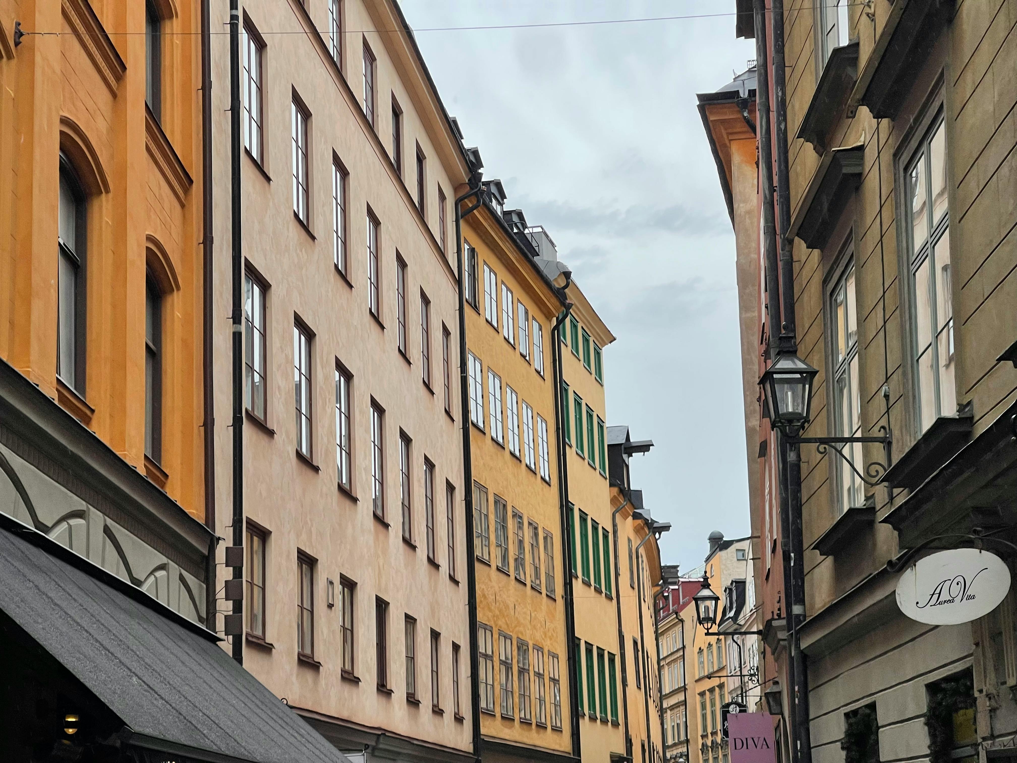 Discover a vibrant street in Stockholm with historic colorful buildings and classic architecture.
