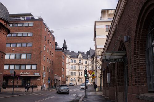 Free Charming city street scene featuring historic architecture and urban life. Stock Photo