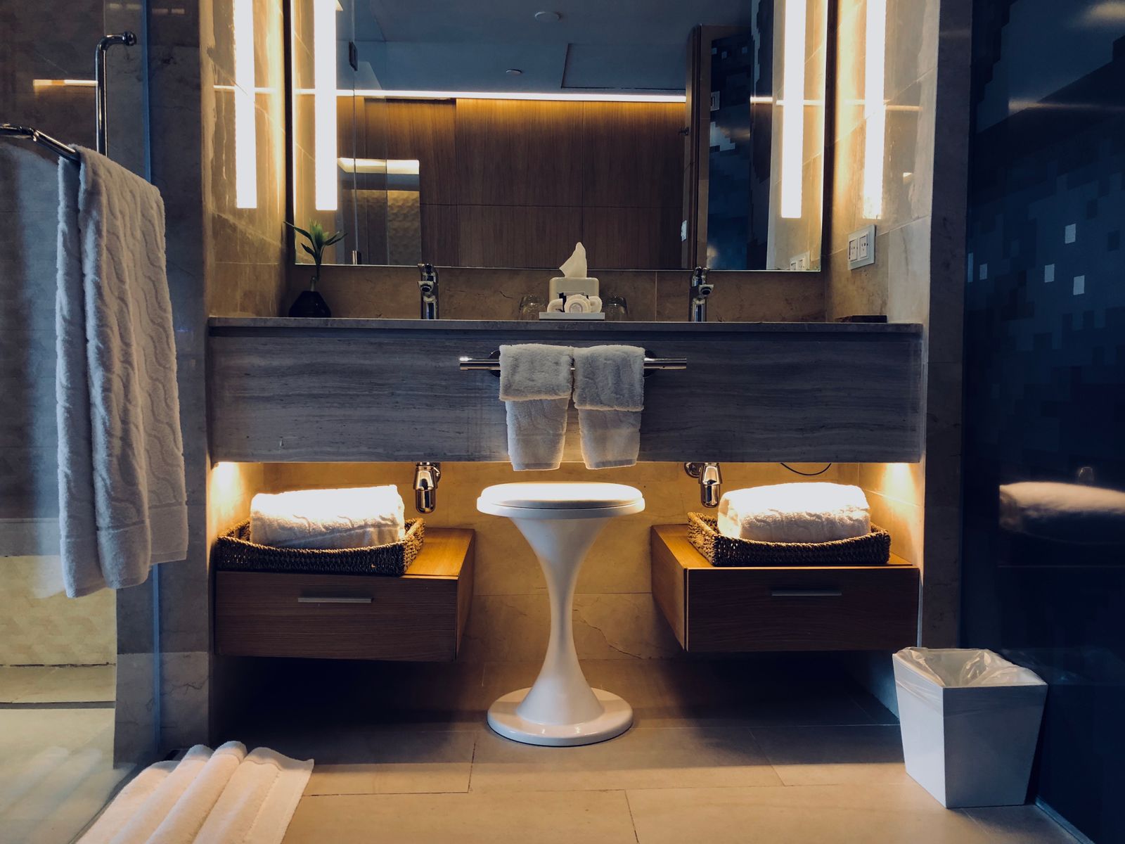 Hotel bathroom with twin basins and warm lighting