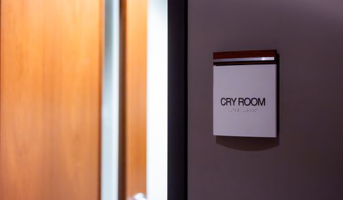 Free Modern interior with a focus on a sign labeled 'Cry Room' mounted on a wall. Stock Photo