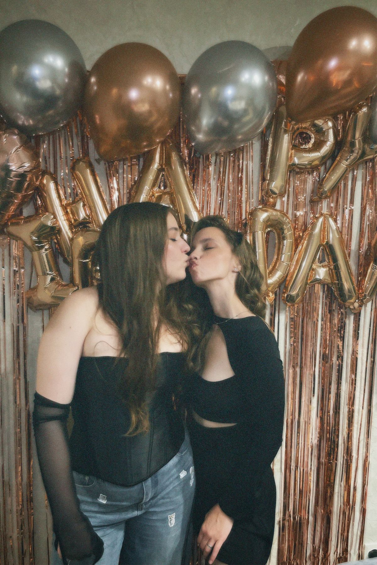 Two women celebrating with birthday balloons