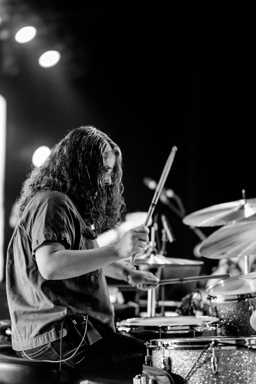 Free Monochrome image capturing a drummer in action during a live music performance. Stock Photo
